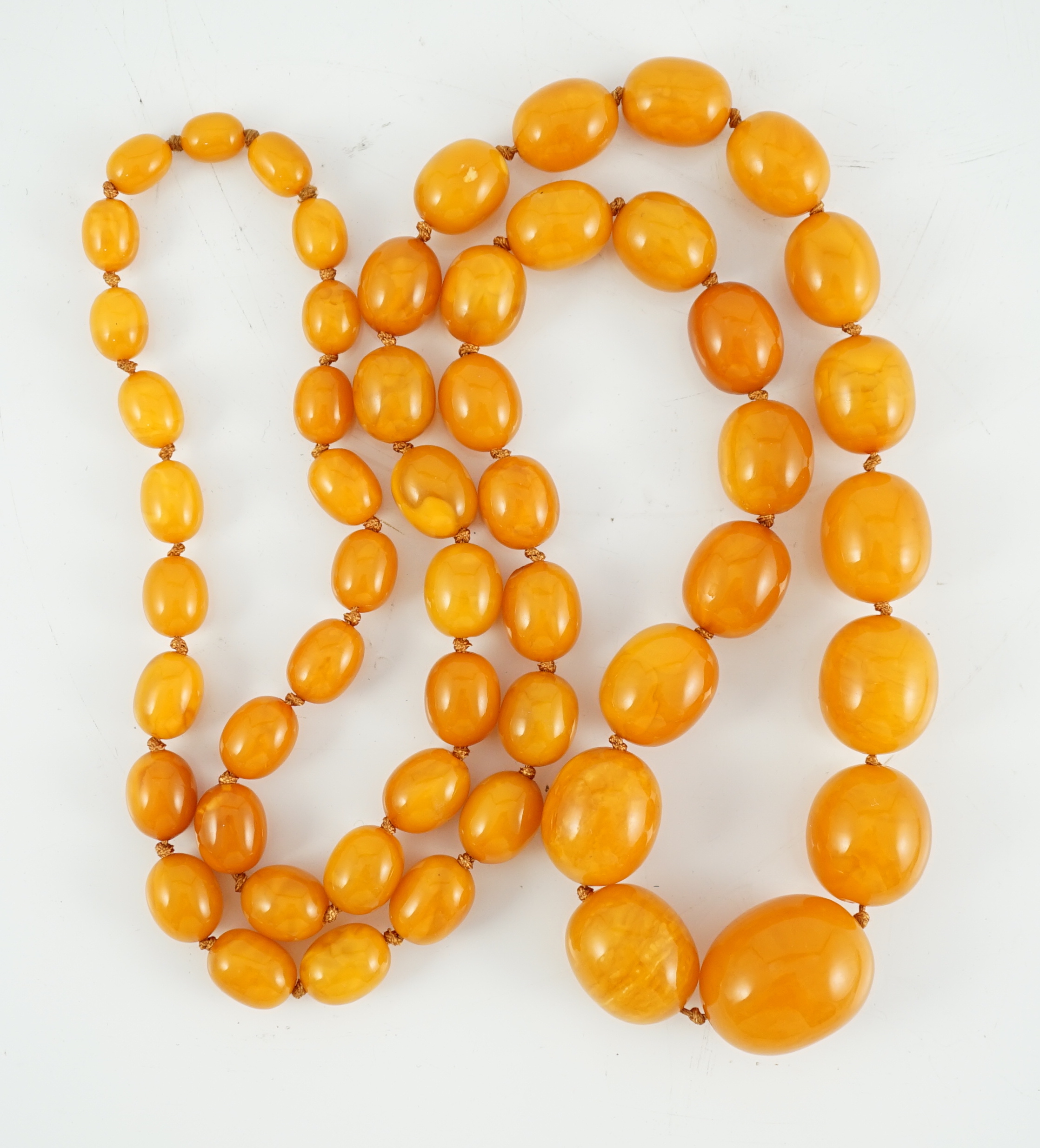 A single strand graduated oval amber bead necklace, 110cm, gross weight 163 grams